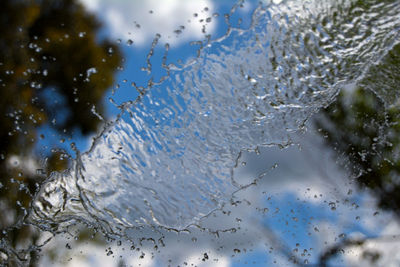 Close-up of splashed water on window