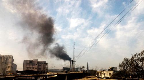 Low angle view of factory against sky