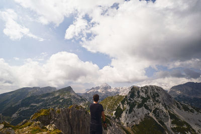 Rear view of man standing on mountain