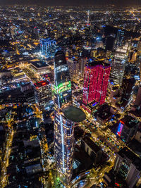 High angle view of illuminated city buildings at night