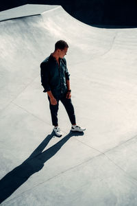Full length of man standing on skateboard