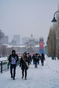 People walking on snow covered landscape