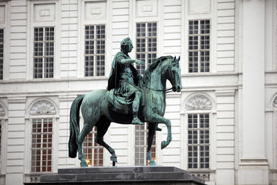 Ancient statue against building