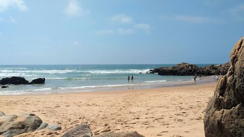 Scenic view of beach against blue sky