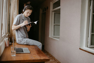 Young man using laptop while sitting at home