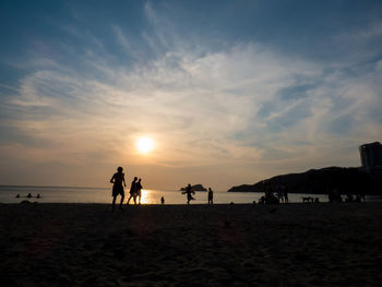 People on beach at sunset