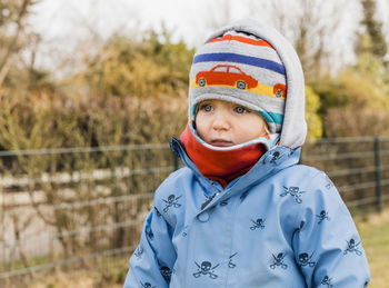 Portrait of boy standing in snow