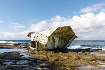 Built structure on beach against sky