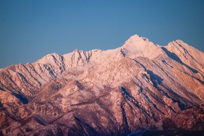 Scenic view of snowcapped mountains against clear sky