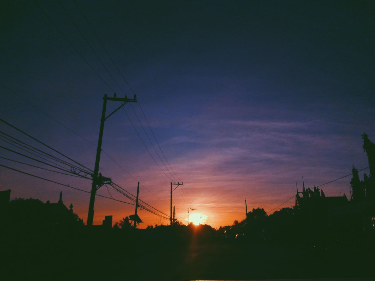 SILHOUETTE ELECTRICITY PYLONS AGAINST SKY DURING SUNSET