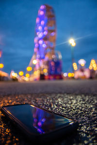 Close-up of illuminated ferris wheel at night