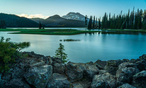 Scenic view of lake and mountains against sky