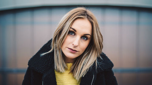 Portrait of beautiful young woman against defocused background