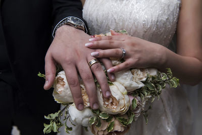 Midsection of couple holding hands