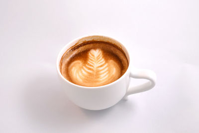 Close-up of coffee cup over white background