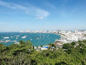 High angle view of city by sea against sky