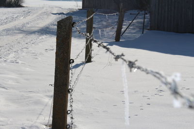 Fence on snow covered landscape