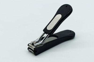 Close-up of metallic structure on table against white background