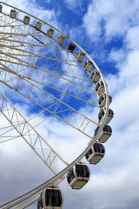 Low angle view of ferris wheel against sky