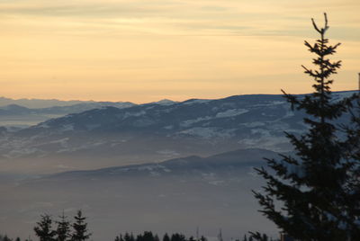 Scenic view of silhouette mountains against sky at sunset