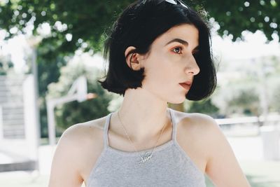 Close-up of beautiful young woman standing outdoors