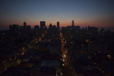 Aerial view of city lit up at night