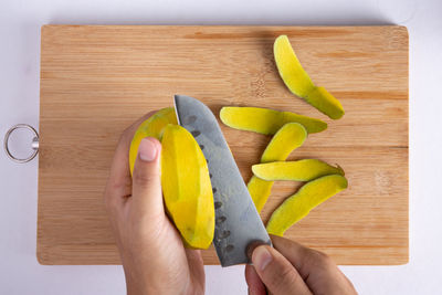 Midsection of person holding ice cream in cutting board