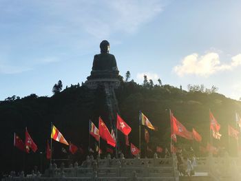 Low angle view of flags against sky