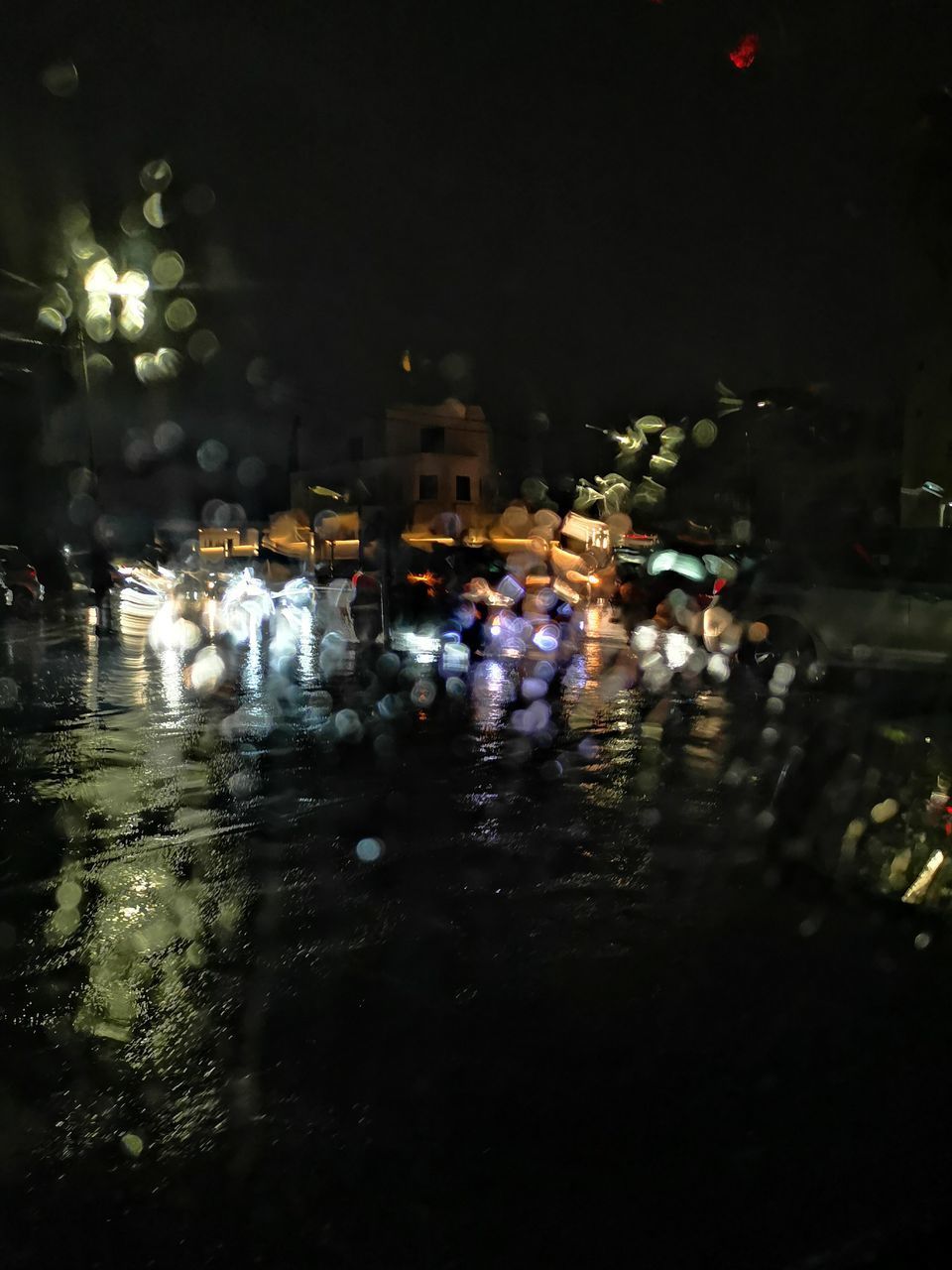 WET ILLUMINATED STREET DURING RAINY SEASON