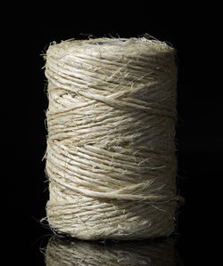 Close-up of stack of rope over black background