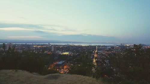 View of cityscape against cloudy sky