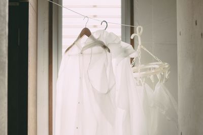 Close-up of clothes hanging on white wall