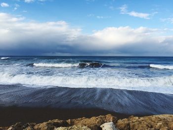 Scenic view of sea against cloudy sky