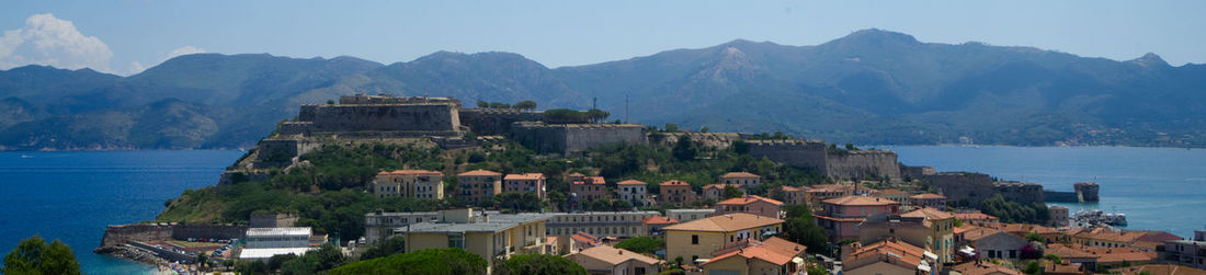 Town by sea against clear sky