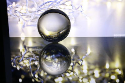 Close-up of crystal ball hanging on glass