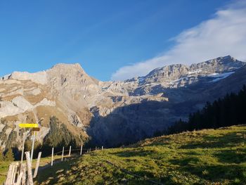 Scenic view of mountains against blue sky