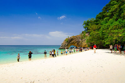 People on beach against sky