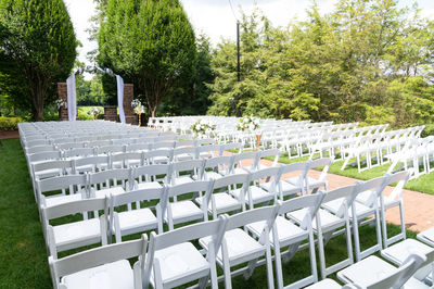 Outdoor wedding area set with white chairs