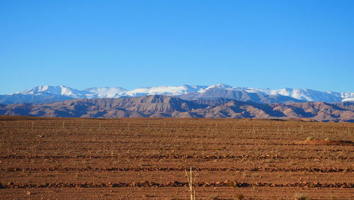 Scenic view of snowcapped mountains against clear blue sky