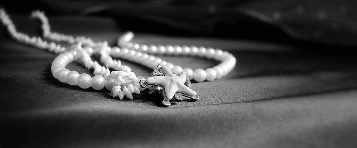 Close-up of pearl necklace on fabric