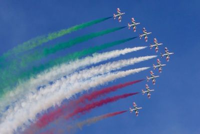 Low angle view of airshow against clear blue sky