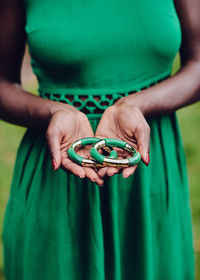 Close-up of woman holding earrings in hand