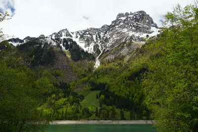 Scenic view of lake and mountains against sky