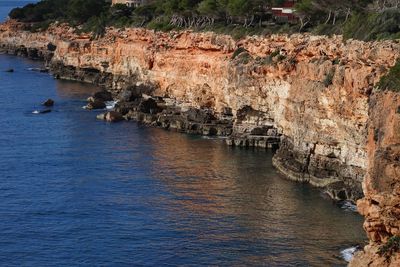 High angle view of rock formations by sea