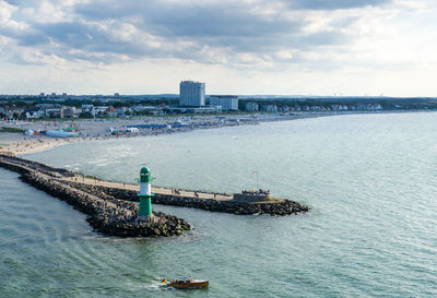 Scenic view of sea and buildings against sky