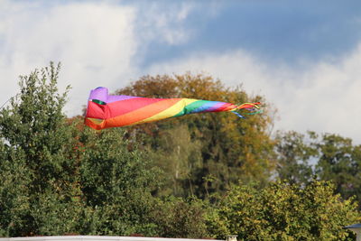 Low angle view of multi colored umbrellas against sky