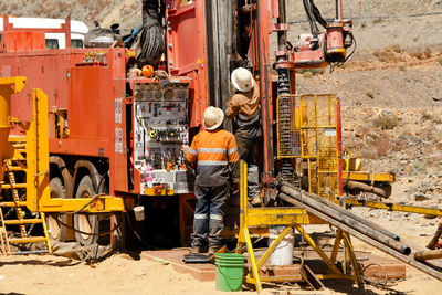 Worker with machinery on field