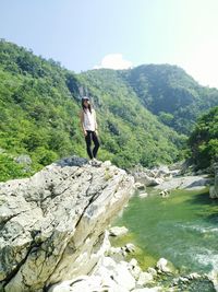 Full length of woman standing on cliff