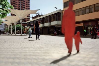 People walking on street in city