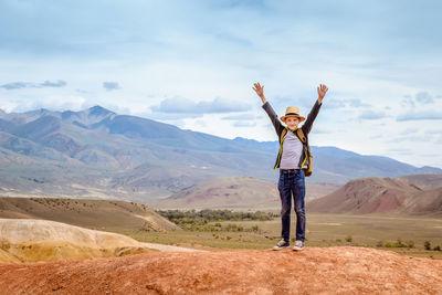 Man standing in front of mountain range against sky